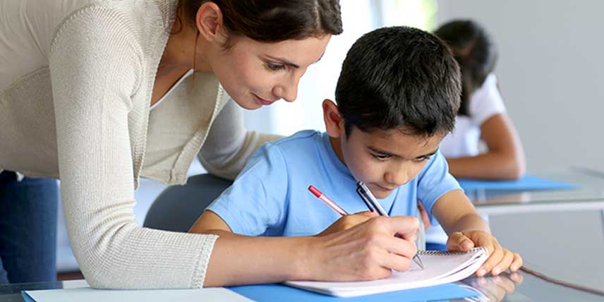 A teacher giving personalised feedback to a child